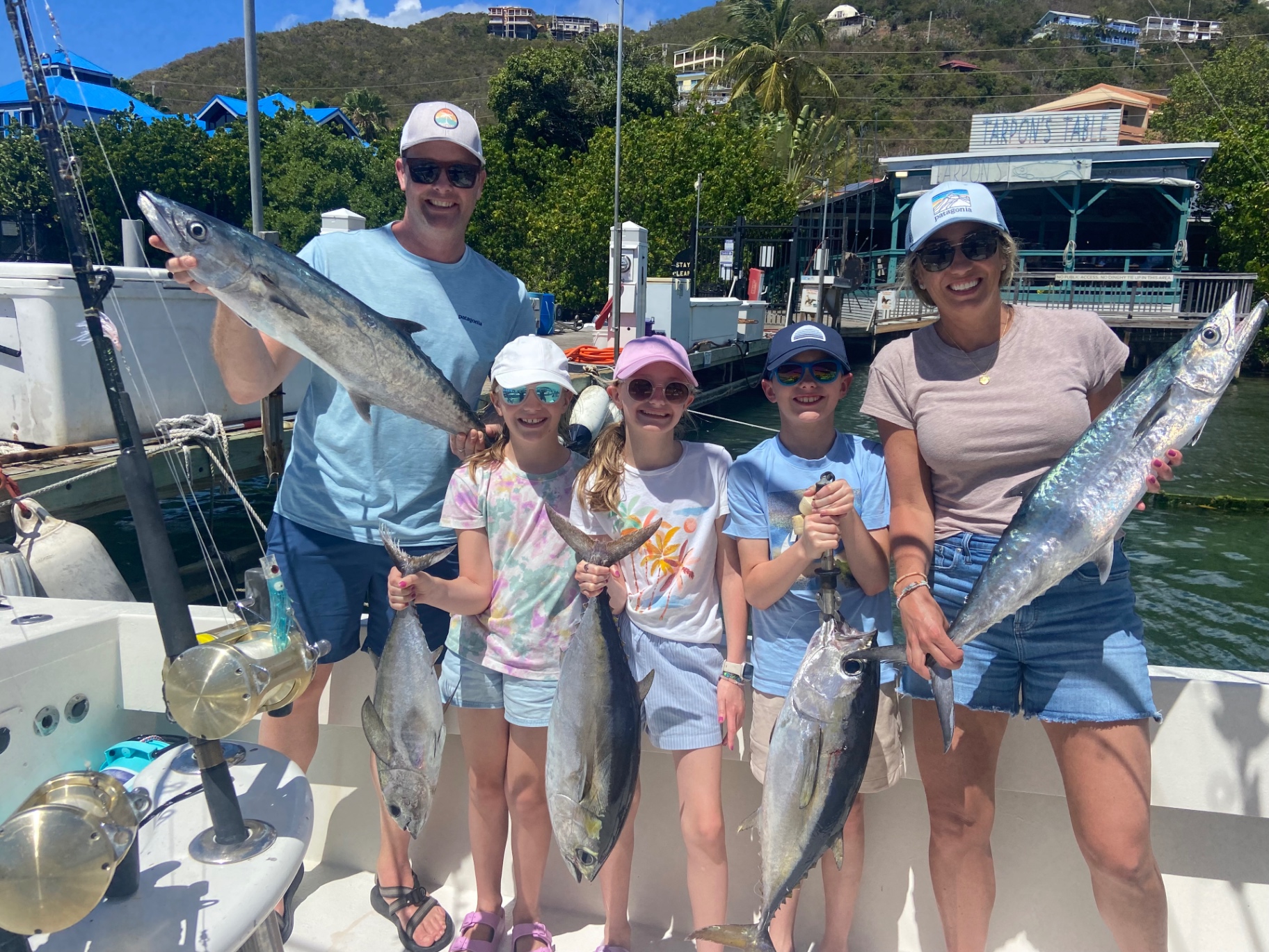 Family of five at the dock with wahoo, tuna and jacks