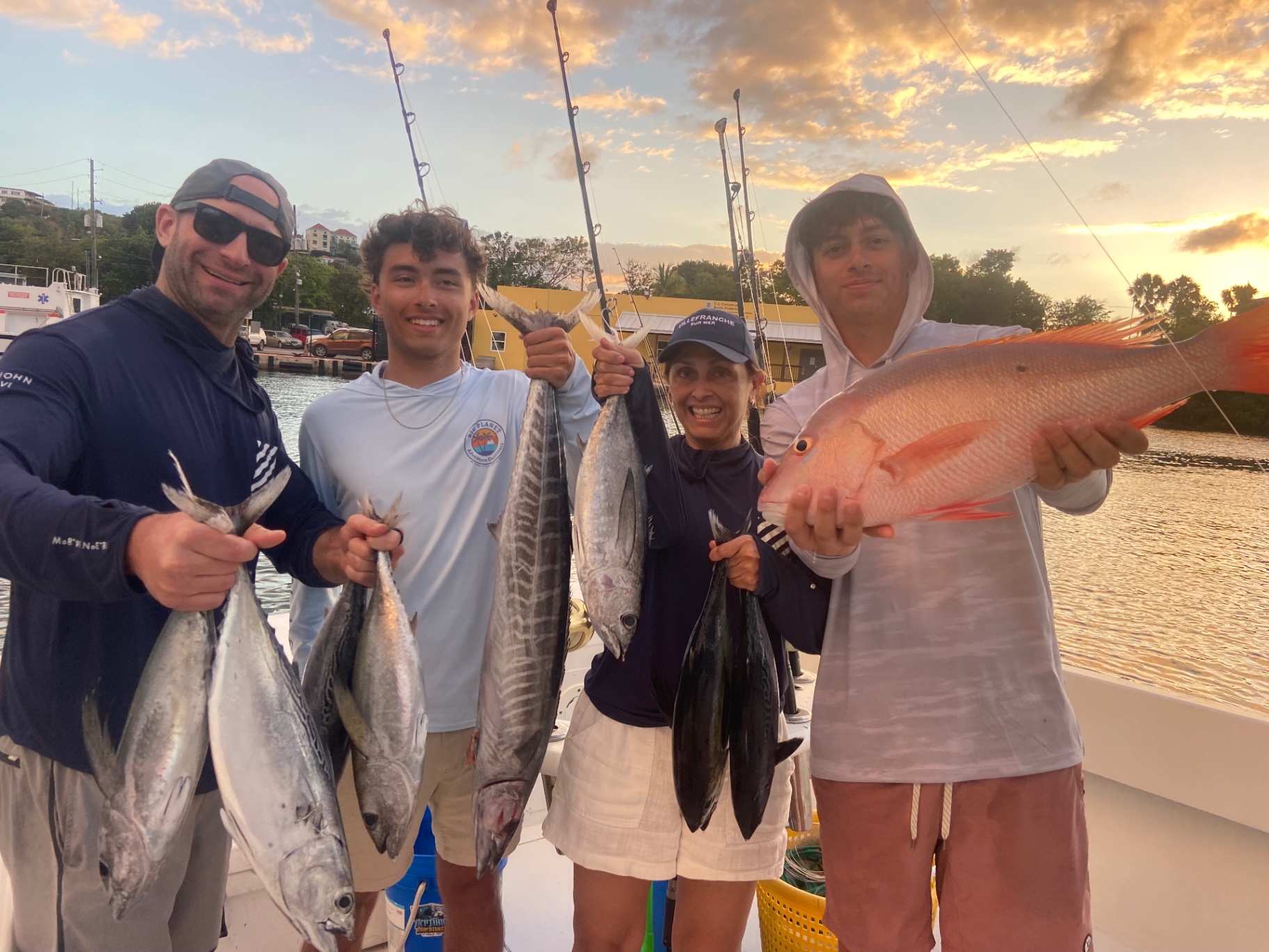 Four anglers at sunrise with tuna, wahoo and a mutton snapper