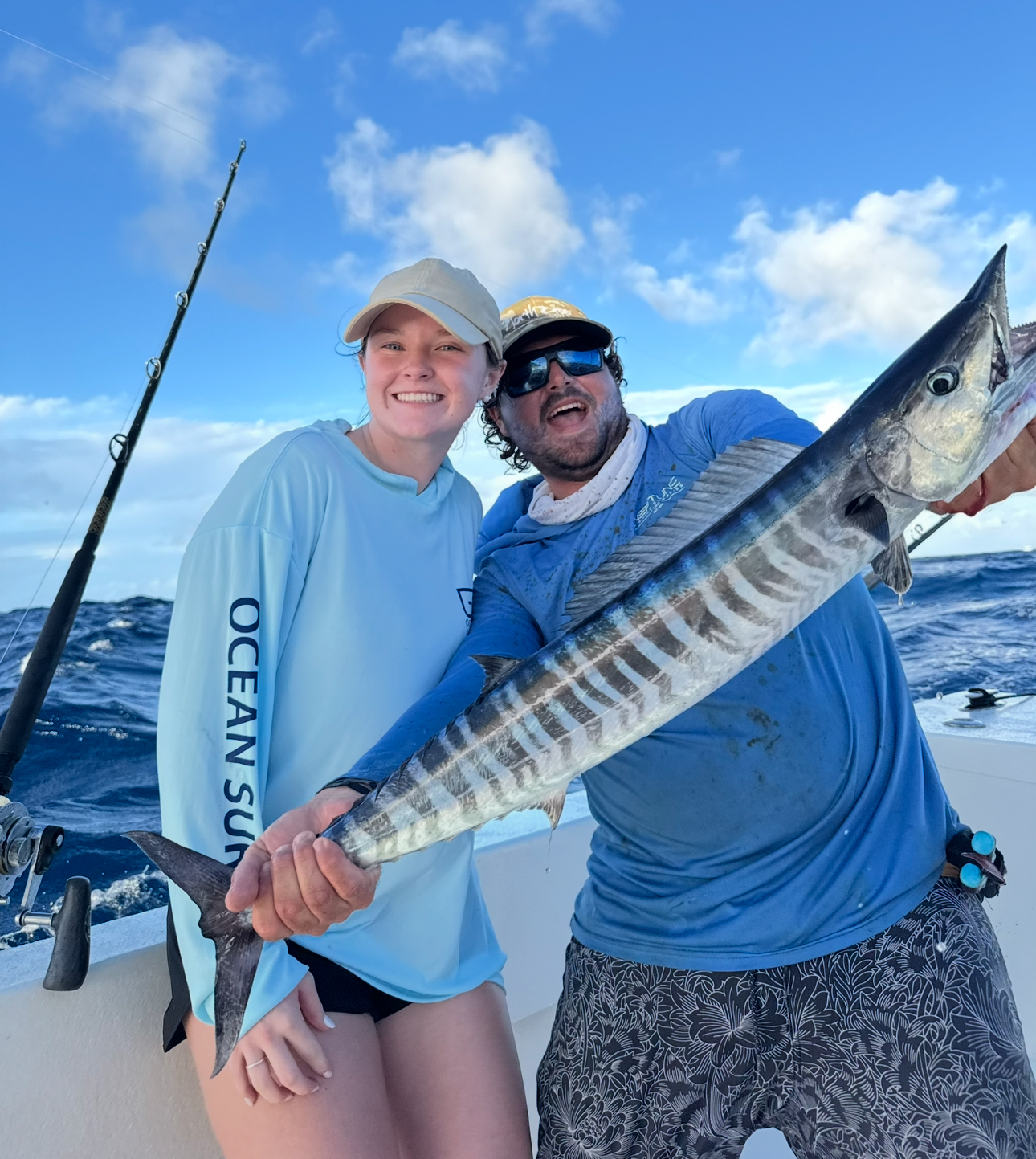 Anglers holding a big wahoo offshore with Captain Carlos aboard Top Shot