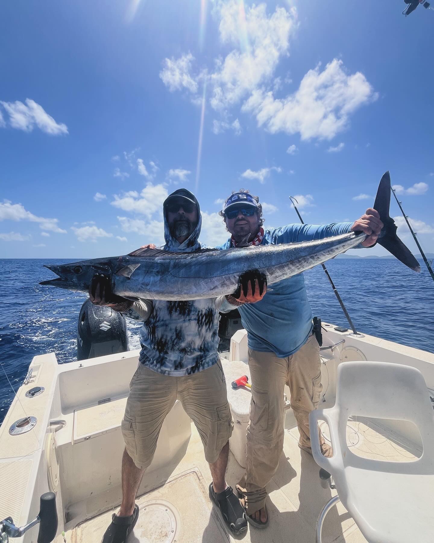 Two anglers with a wahoo caught in deep Caribbean water