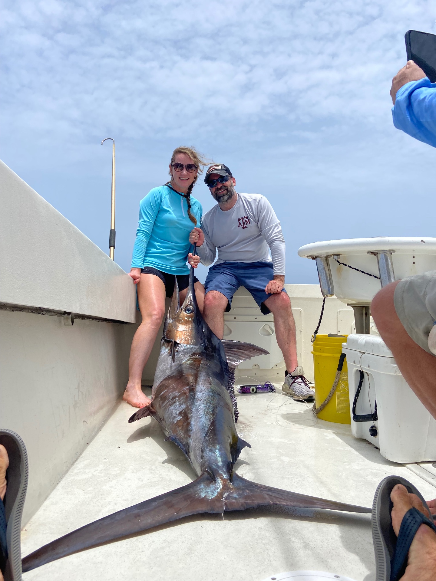 Couple with a swordfish on the deck of Top Shot