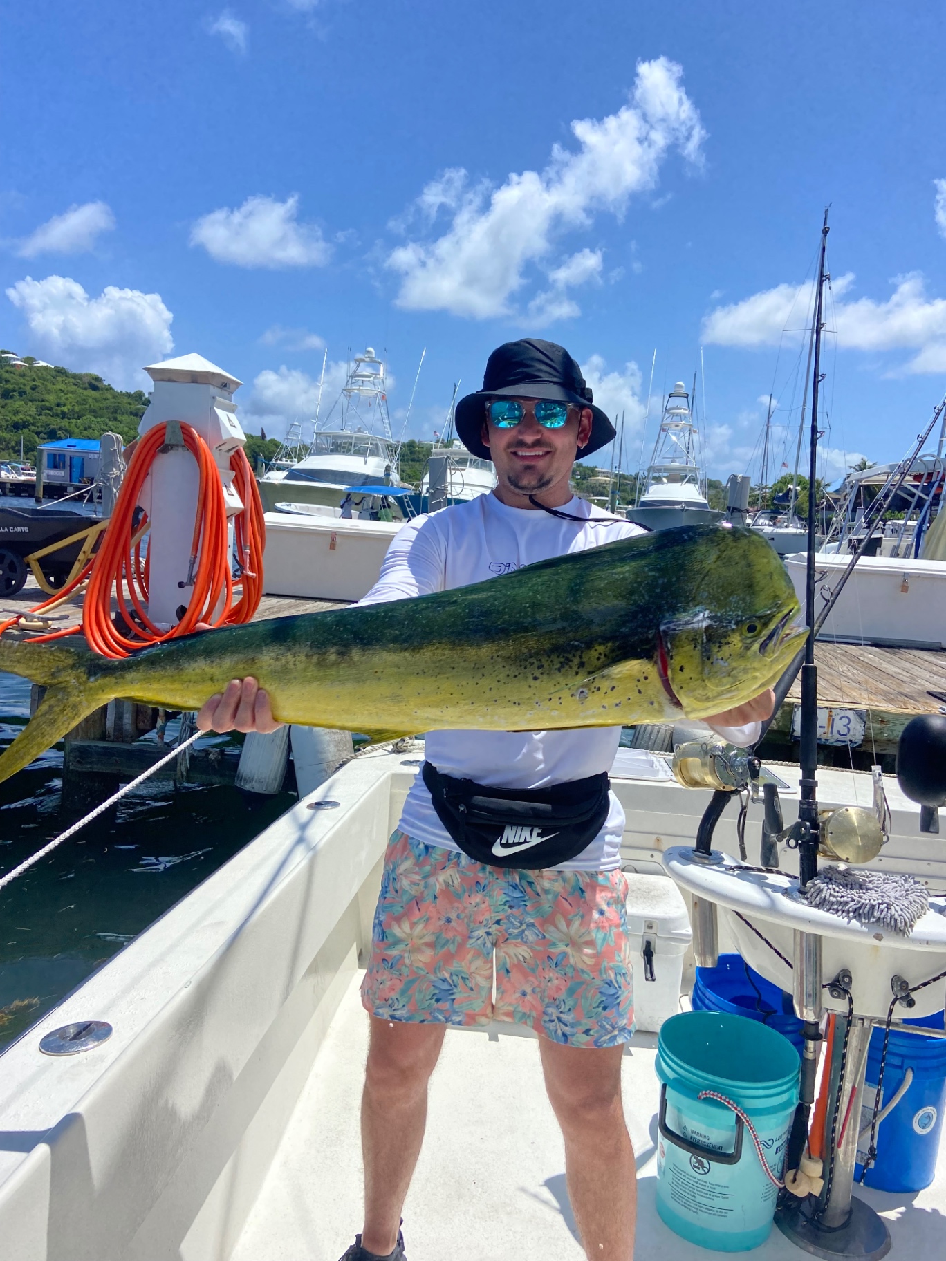 Angler holding a bull mahi at the marina