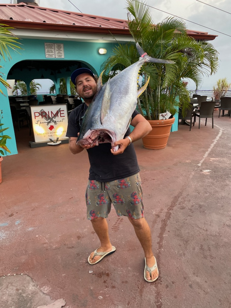 Captain Carlos shouldering a big yellowfin tuna at the dock